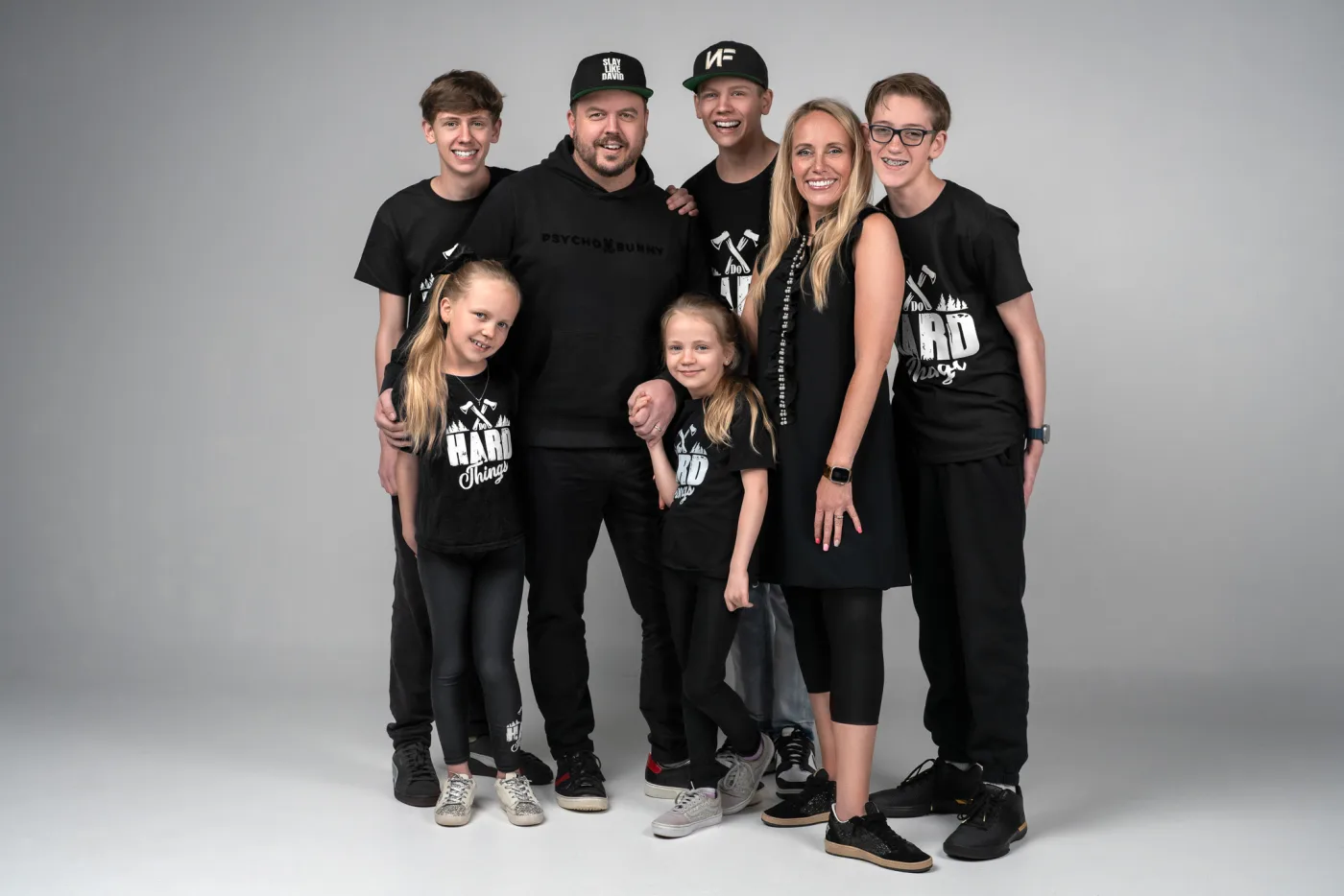 Josh and Ashlee Latimer with their five kids, all in black Do Hard Things shirts